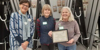 Carol (right) hands over the baton to Joan Cote and Cindy Marble (center and left).